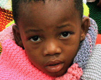 Teach knitting to warm this child